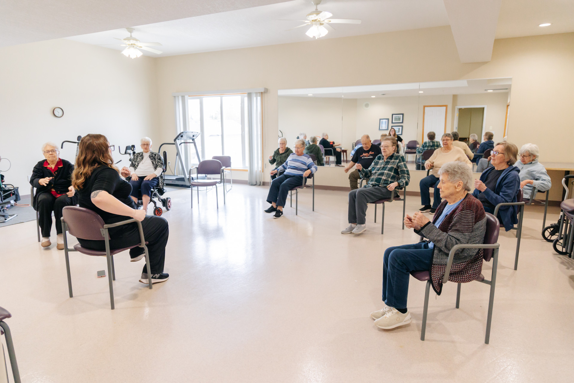 Senior residents participating in a guided group activity in the Harvest House fitness and wellness room, Olds Alberta