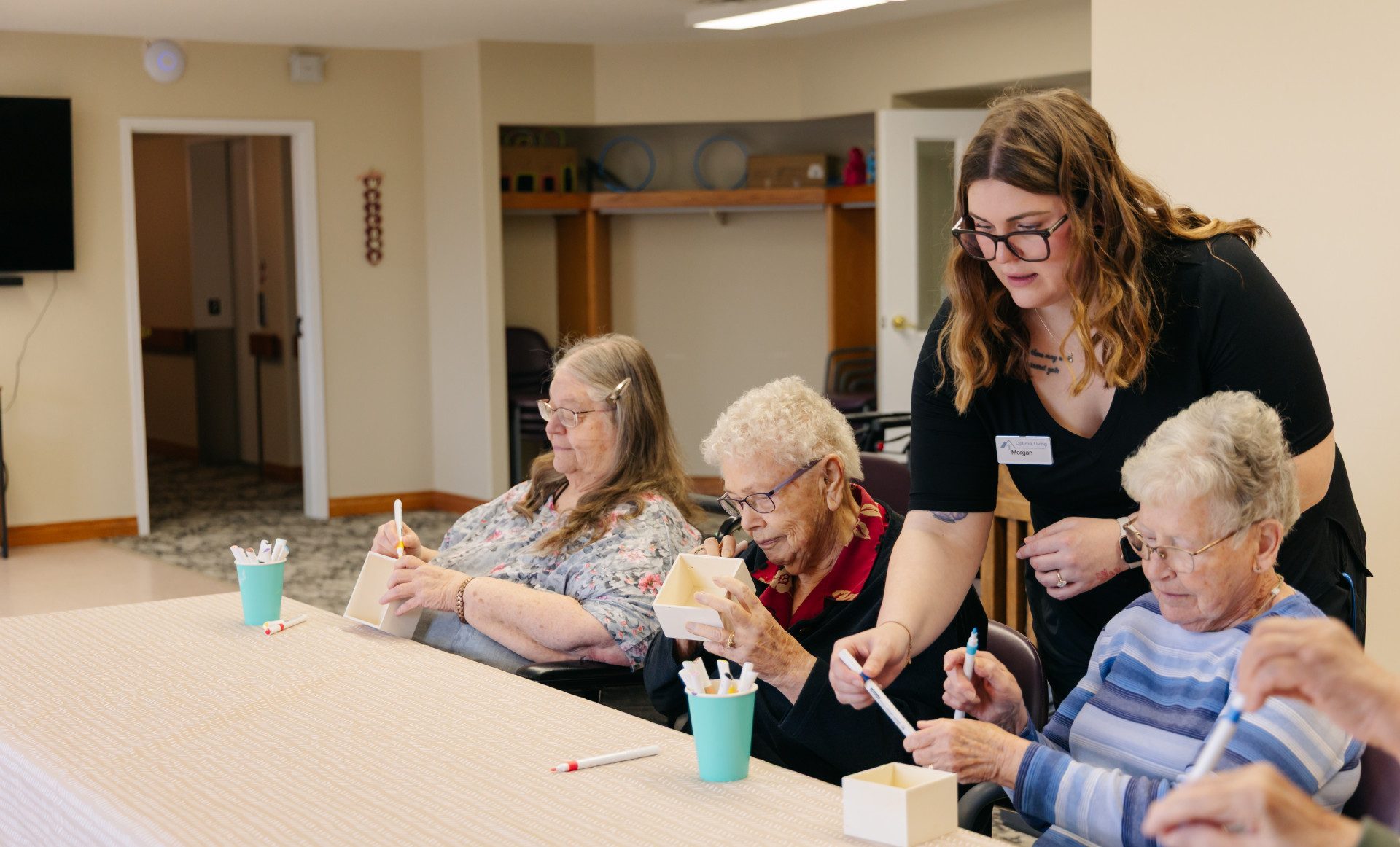 Residents and team members spending time together in the Harvest House common area