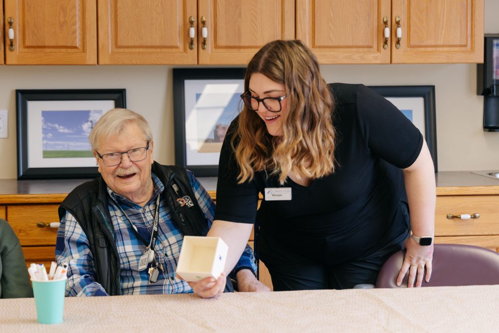 Harvest House assisted living caregiver and senior resident sharing a caring moment